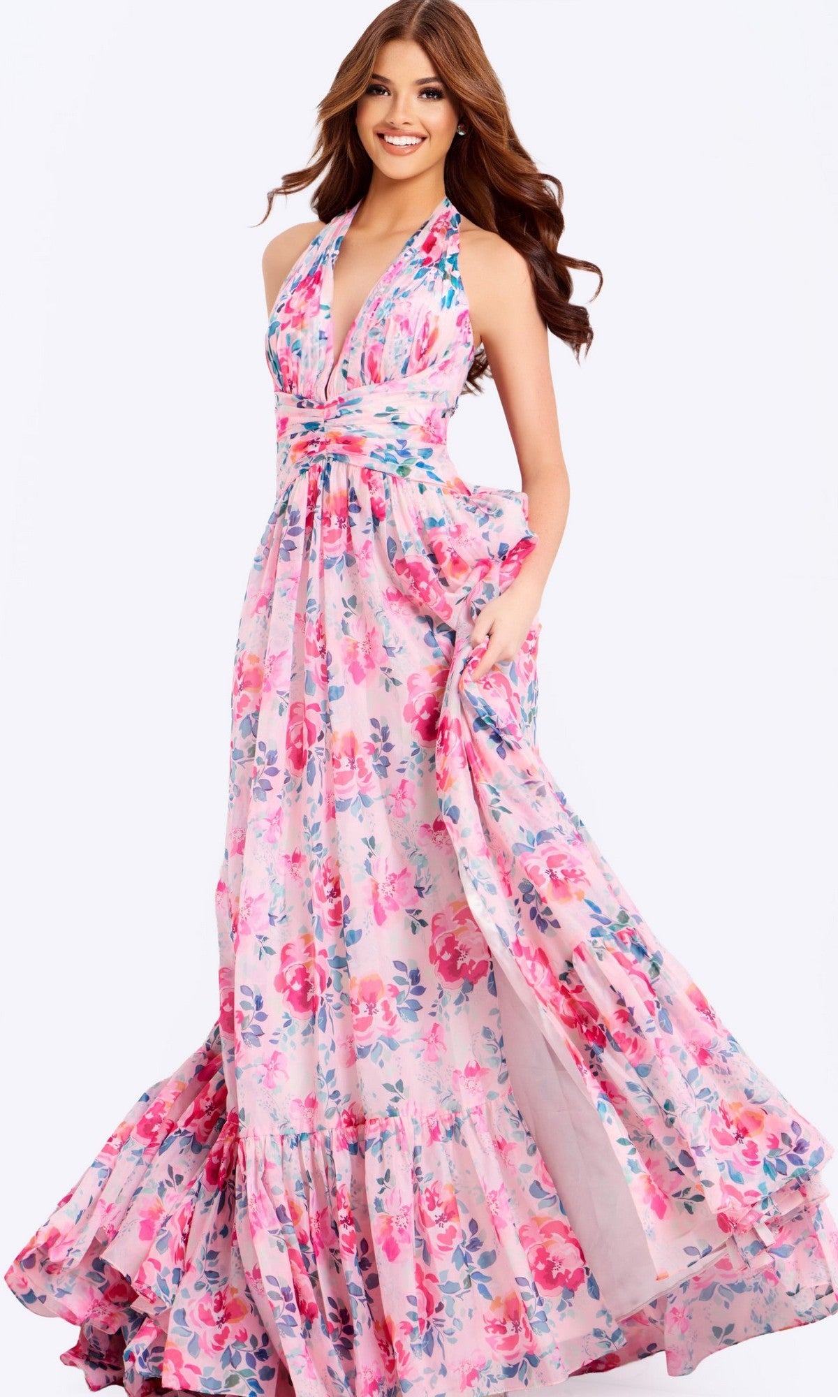 Woman wearing the Jovani 48469 long prom dress in print, featuring a sleeveless design and flowing skirt, posing and smiling against a plain background.